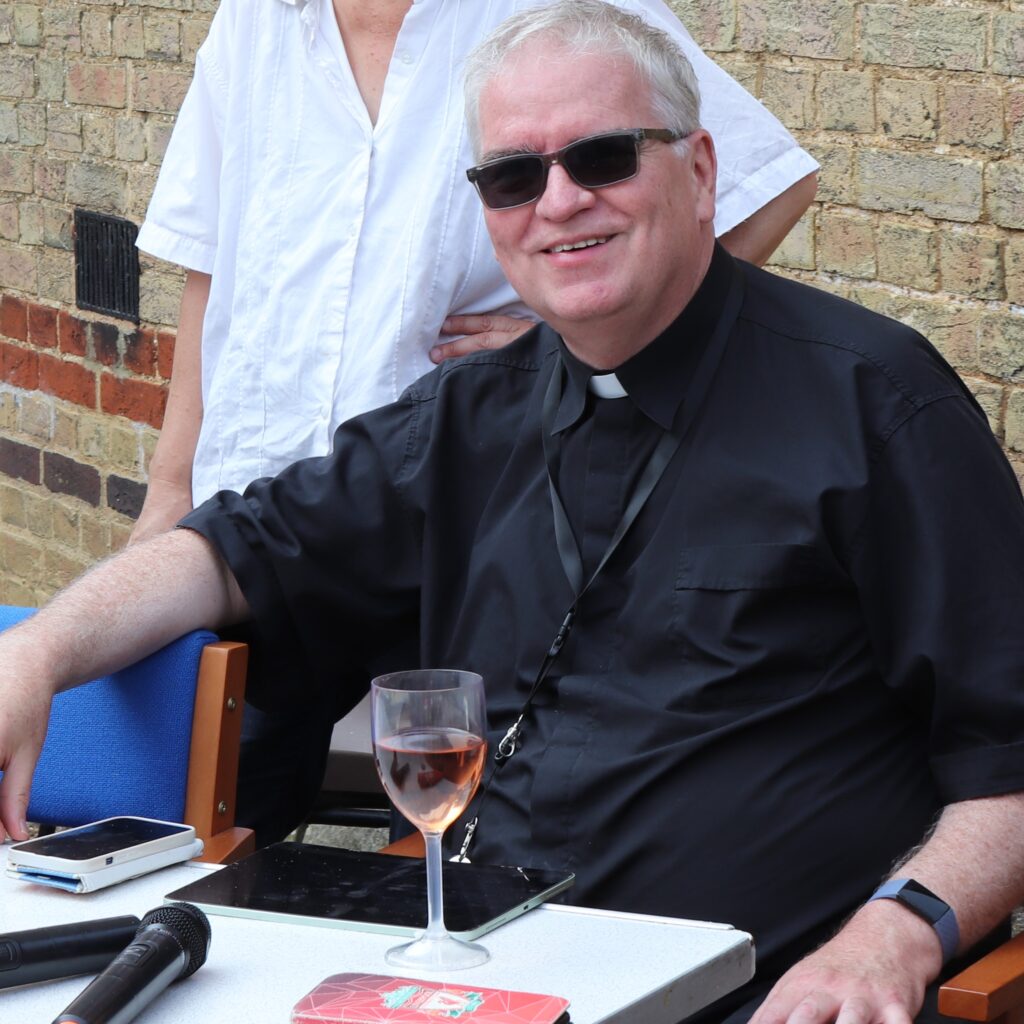 Absent mindedly, a former wine merchant enjoys a glass rose wine.